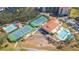 Aerial view of the tennis courts, pools, and clubhouse showcasing the community amenities at 438 Mariner Dr, Tarpon Springs, FL 34689