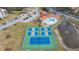 Aerial view of the tennis courts, pool, and parking, showing the community layout at 438 Mariner Dr, Tarpon Springs, FL 34689