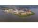 Beautiful aerial view of a waterfront condo community, with various amenities and lush landscaping at 438 Mariner Dr, Tarpon Springs, FL 34689