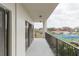 Balcony with railings overlooking trees and tennis courts, offering a serene outdoor retreat at 438 Mariner Dr, Tarpon Springs, FL 34689
