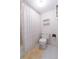 Cozy bathroom featuring a toilet and tub with a patterned shower curtain and a shelf at 438 Mariner Dr, Tarpon Springs, FL 34689