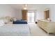 Bright bedroom with carpet flooring, ensuite bathroom, and sliding doors leading to a balcony at 438 Mariner Dr, Tarpon Springs, FL 34689