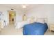 Bright bedroom featuring two twin beds and an adjoining bathroom for convenience at 438 Mariner Dr, Tarpon Springs, FL 34689