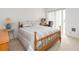 Comfortable bedroom with a large bed, desk, and sliding doors to the outside at 438 Mariner Dr, Tarpon Springs, FL 34689