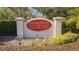 Mariner Village at Tarpon Cove community sign surrounded by landscaping and greenery at 438 Mariner Dr, Tarpon Springs, FL 34689