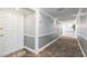 Inviting hallway featuring neutral colors, carpet flooring, and well-lit entrance to unit 438 at 438 Mariner Dr, Tarpon Springs, FL 34689