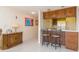 Kitchen area featuring bar seating, bright lighting, and a view of the adjacent living area at 438 Mariner Dr, Tarpon Springs, FL 34689