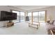 Spacious living area featuring a private balcony, carpet floors, and ample sunlight at 438 Mariner Dr, Tarpon Springs, FL 34689