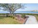 Scenic view of the waterfront with a walking path and bench for relaxing at 438 Mariner Dr, Tarpon Springs, FL 34689