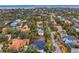 Aerial view shows land parcel amongst mature trees and neighborhood homes with the city in the distance at 4610 W Lamb Ave, Tampa, FL 33629