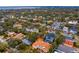 Aerial view showcases neighborhood homes amidst mature trees; cleared lot is centrally located at 4610 W Lamb Ave, Tampa, FL 33629