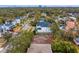 An aerial view shows the cleared lot amongst mature trees, neighboring houses, and sidewalks at 4610 W Lamb Ave, Tampa, FL 33629