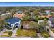 An aerial view shows a cleared parcel of land surrounded by mature trees and neighboring houses at 4610 W Lamb Ave, Tampa, FL 33629