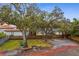 Residential lot with trees showing the potential for a custom home build within a neighborhood setting at 4610 W Lamb Ave, Tampa, FL 33629