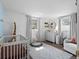 Charming Bedroom with a crib, dresser, and play area for a comfortable setting at 5117 School Rd, New Port Richey, FL 34653