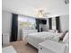 Bright bedroom with a large window, dresser, and minimalist decor at 5117 School Rd, New Port Richey, FL 34653