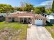 Charming single-story home with a cozy front porch, manicured lawn, and a convenient one-car garage at 5117 School Rd, New Port Richey, FL 34653