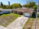 Charming single-story home with a well-manicured lawn and a driveway at 5117 School Rd, New Port Richey, FL 34653