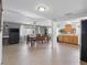 Open floor plan showing dining area and kitchen with light tile floors and natural light at 5117 School Rd, New Port Richey, FL 34653