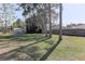 Expansive backyard with lush grass, mature trees, and shed at 5155 Kenmore St, Spring Hill, FL 34608