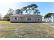 Charming single-story home featuring a well-maintained lawn, white shutters, and a welcoming front entrance at 5155 Kenmore St, Spring Hill, FL 34608