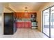 Kitchen featuring stainless steel appliances, wood cabinets, and plenty of natural light at 5155 Kenmore St, Spring Hill, FL 34608
