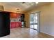 Eat-in kitchen area featuring wooden cabinets and sliding glass doors leading to a screened-in lanai at 5155 Kenmore St, Spring Hill, FL 34608