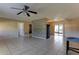 Open-concept living space with tile flooring, a ceiling fan, and easy access to other parts of the home at 5155 Kenmore St, Spring Hill, FL 34608
