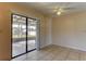 Bright living room with tiled floor and sliding doors to the outside patio area at 5155 Kenmore St, Spring Hill, FL 34608