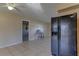 Living room with tiled floor and black refrigerator at 5155 Kenmore St, Spring Hill, FL 34608