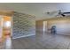Bright living room featuring tile flooring, a modern accent wall, and neutral paint at 5155 Kenmore St, Spring Hill, FL 34608