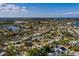 Aerial view of a residential neighborhood, highlighting the property's pool and lush greenery at 5611 Venetian Ne Blvd, St Petersburg, FL 33703