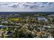 An aerial view of a single-story house nestled in a serene neighborhood near a large park and a lake at 5611 Venetian Ne Blvd, St Petersburg, FL 33703