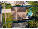 Aerial view of the house featuring backyard pool, patio, driveway, and lush green lawn at 5611 Venetian Ne Blvd, St Petersburg, FL 33703