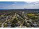 Aerial view of a residential area near a bay, showcasing a home with a pool and mature trees at 5611 Venetian Ne Blvd, St Petersburg, FL 33703