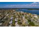 Picturesque aerial view of a waterfront neighborhood highlighting homes with lush trees and serene surroundings at 5611 Venetian Ne Blvd, St Petersburg, FL 33703