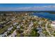 An aerial view of a single-story home with a private pool in a waterfront community with lush trees at 5611 Venetian Ne Blvd, St Petersburg, FL 33703