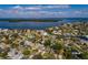 An aerial view of a cozy single-story home nestled in a waterfront community with beautiful water views at 5611 Venetian Ne Blvd, St Petersburg, FL 33703