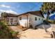 The home's backyard shows a patio area with landscaping, a screen room, and a beautiful palm tree at 5611 Venetian Ne Blvd, St Petersburg, FL 33703