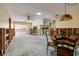 Dining room area featuring a ceiling fan, exposed walls, and a decorative Tiffany-style lamp over a wood table at 5611 Venetian Ne Blvd, St Petersburg, FL 33703