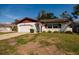 Charming single-Gathering home featuring a well-manicured front lawn, attached garage, and cozy curb appeal at 5611 Venetian Ne Blvd, St Petersburg, FL 33703