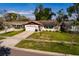 Charming single-story home featuring a well-maintained lawn, attached garage, and an inviting entrance at 5611 Venetian Ne Blvd, St Petersburg, FL 33703