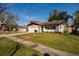 Charming single-story home featuring a well-maintained lawn, attached garage, and an inviting entrance at 5611 Venetian Ne Blvd, St Petersburg, FL 33703