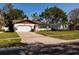 Charming home with a spacious driveway, two-car garage, manicured lawn, and lovely curb appeal at 5611 Venetian Ne Blvd, St Petersburg, FL 33703