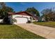 Charming single-story home featuring a two-car garage, well-maintained lawn, and a welcoming entrance at 5611 Venetian Ne Blvd, St Petersburg, FL 33703