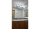 Bathroom featuring wood cabinets, a granite countertop, and bright lighting at 6011 Skydale Way # 101, Riverview, FL 33578