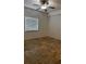 This bedroom features neutral walls, tile flooring, and a ceiling fan at 6011 Skydale Way # 101, Riverview, FL 33578