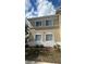Beige two-story home with white-framed windows and well-maintained landscaping at 6011 Skydale Way # 101, Riverview, FL 33578