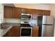 Modern kitchen with stainless steel appliances, granite countertops, and wood cabinetry at 6011 Skydale Way # 101, Riverview, FL 33578