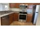 Well-lit kitchen features stainless steel appliances and light brown cabinets at 6011 Skydale Way # 101, Riverview, FL 33578